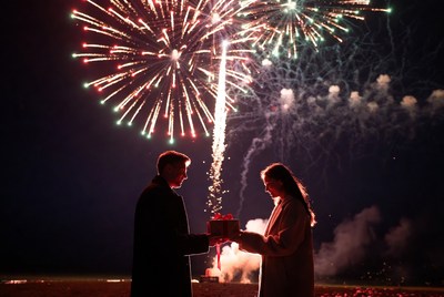 Romantic gift exchange under fireworks