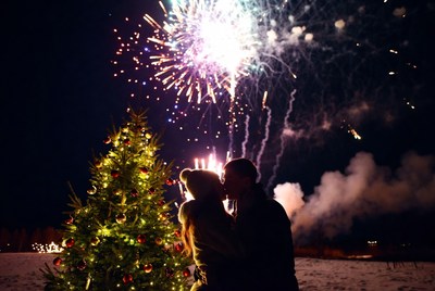 Couple kissing under fireworks