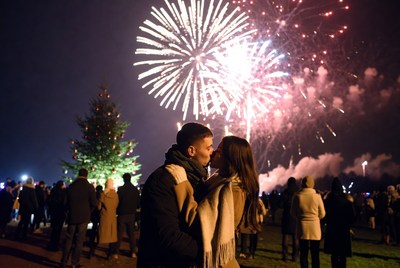 Couple shares a kiss under fireworks