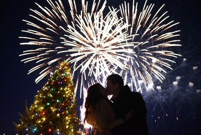 Couple kissing under fireworks display