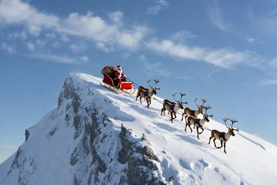 Santa claus flying over snowy mountain