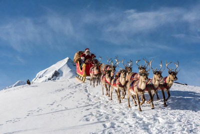 Santa claus rides sleigh with reindeer in winter