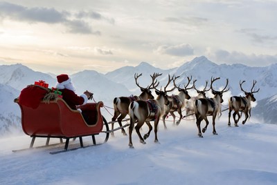 Santa claus riding reindeer sleigh