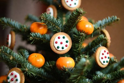 Festive cookies and oranges on tree