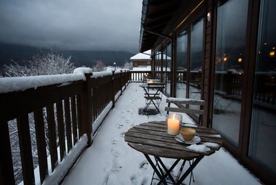 Winter balcony with snow and candlelight