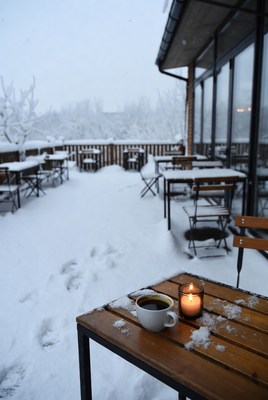Snowy cafe terrace with warm drink