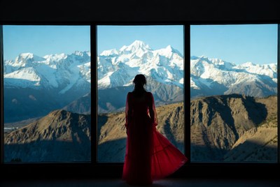 Woman in red dress against mountain view