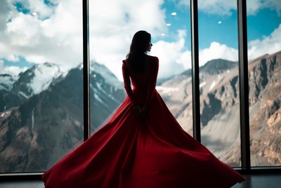 Woman in red dress with mountains view