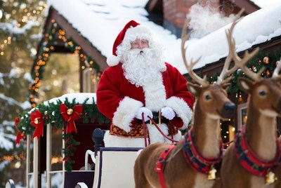 Santa with reindeer in winter wonderland