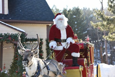 Santa claus with reindeer in winter town