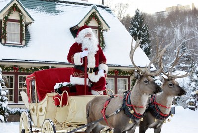 Santa in snowy village with reindeer