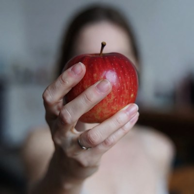 Holding a red apple in hand