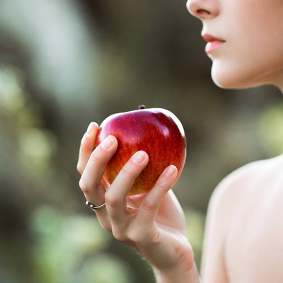 Holding a fresh red apple