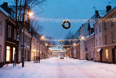 Snowy street decorated for winter evening
