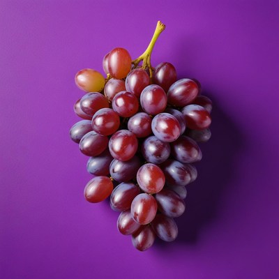 Fresh red grapes on purple surface