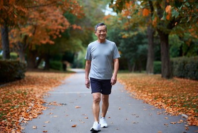 Senior man walking in autumn park