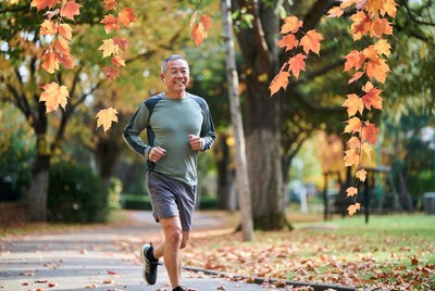 Joyful jogger in autumn park
