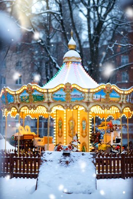 Snowy carousel in festive lights