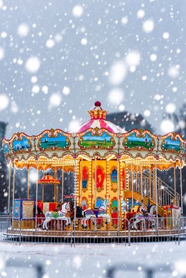 Colorful carousel in the snowy park