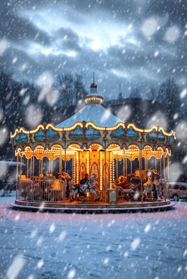 Snowy carousel in winter evening glow