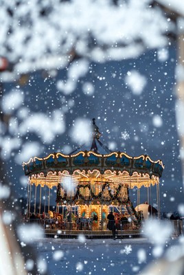 Winter carousel amidst falling snow