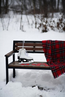 Ice skates on a snowy bench