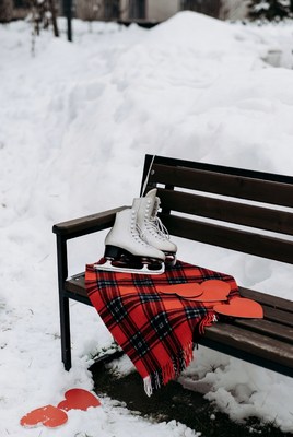 Ice skates resting on snowy bench