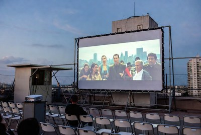 Outdoor movie screening on rooftop at dusk