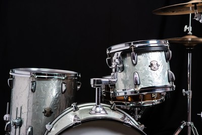 Silver drum set on black background
