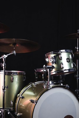 Modern drum set on black background