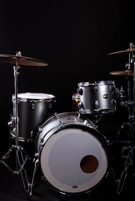 Silver drum set on black backdrop