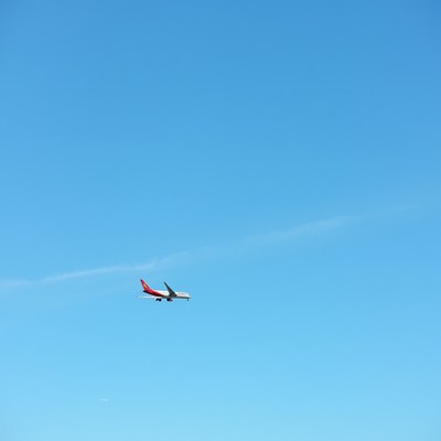 Plane flying in clear blue sky