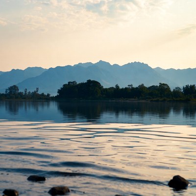 Serene lake at sunset with mountains