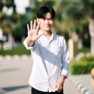 Young man gesturing outdoors