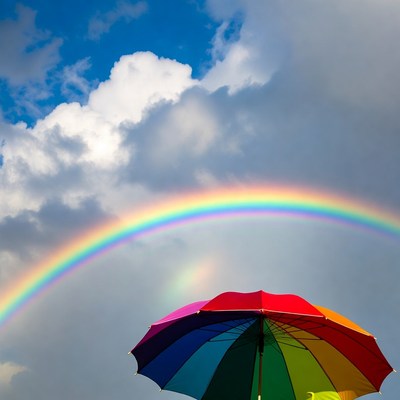 Rainbow above a colorful umbrella