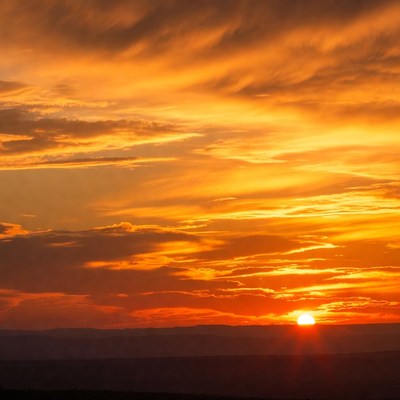 Sunset over the horizon with clouds