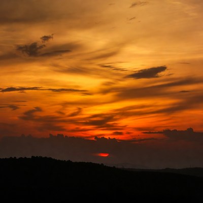 Sunset over distant hills marks end of day