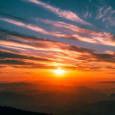 Sunset over mountain landscape in clouds