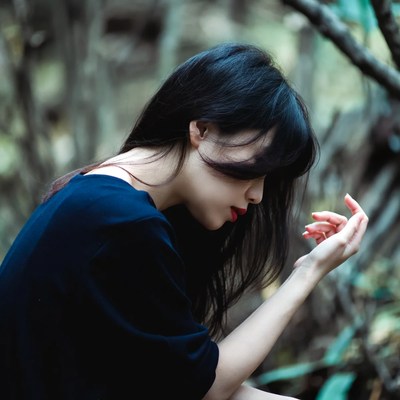 Woman sitting in forest