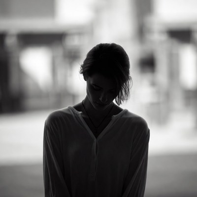 Woman standing alone in shadow