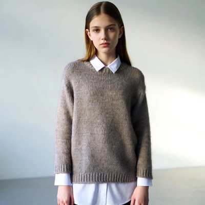 Young person wearing sweater indoors