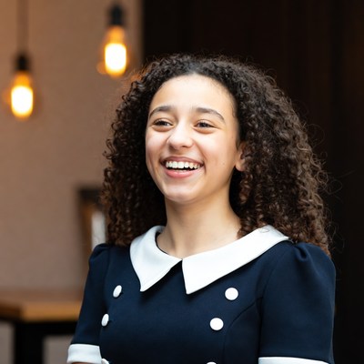 Young girl smiling indoors during daytime