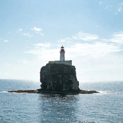 Lighthouse standing on a rock in the ocean