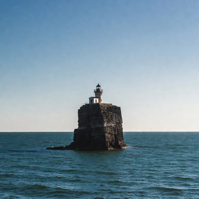 Lighthouse on rocky island in ocean