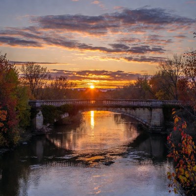 Sunset over river and bridge