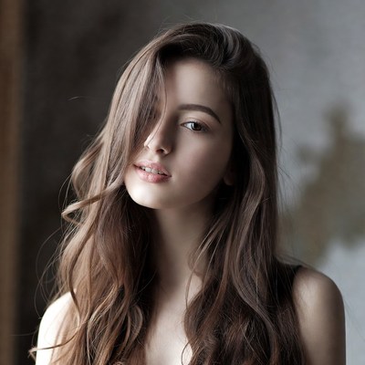 Woman with long hair posing indoors