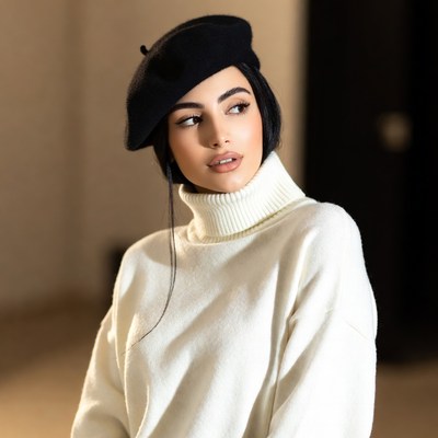 Young woman poses in a beret