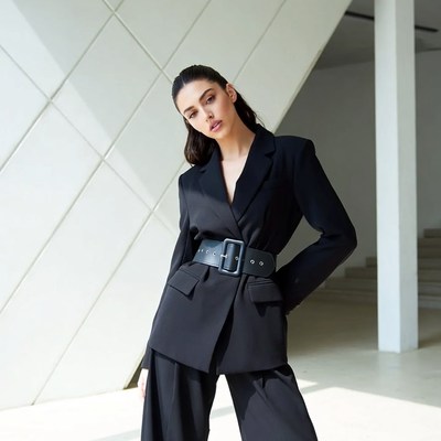 Model poses in black outfit indoors