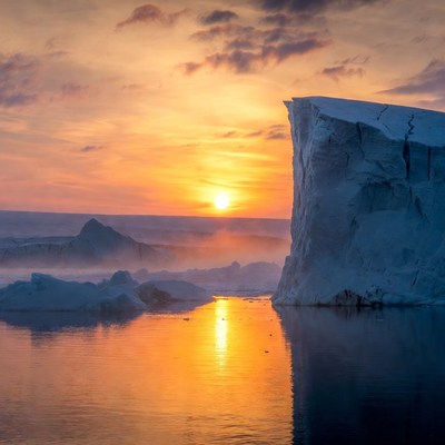 Sunset over icy landscape with reflections