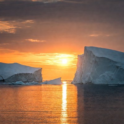 Icebergs and sunset over water